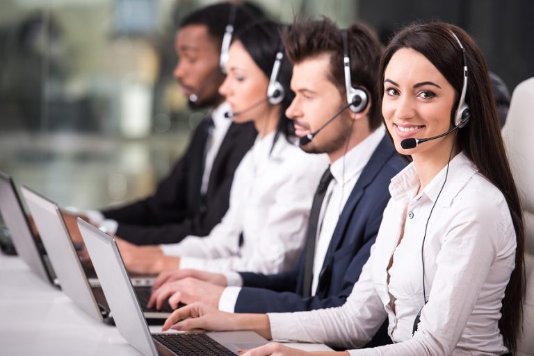 call center team with headsets and laptops