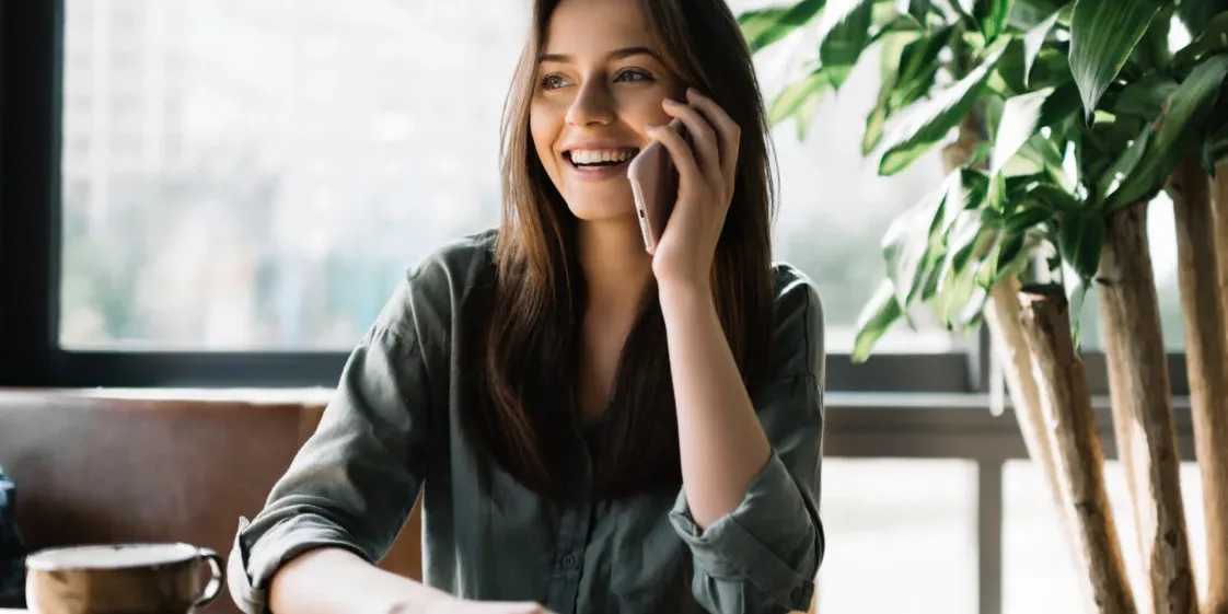Young beautiful woman using mobile phone in modern coffee shop. woman on cell phone