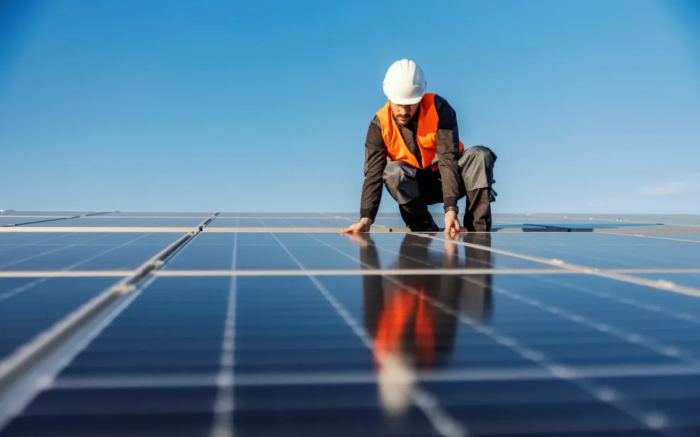 A handyman installing solar panels on the rooftop. work with solar panels