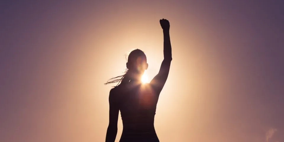 solar-appointment-setting woman with fist up in front of sun